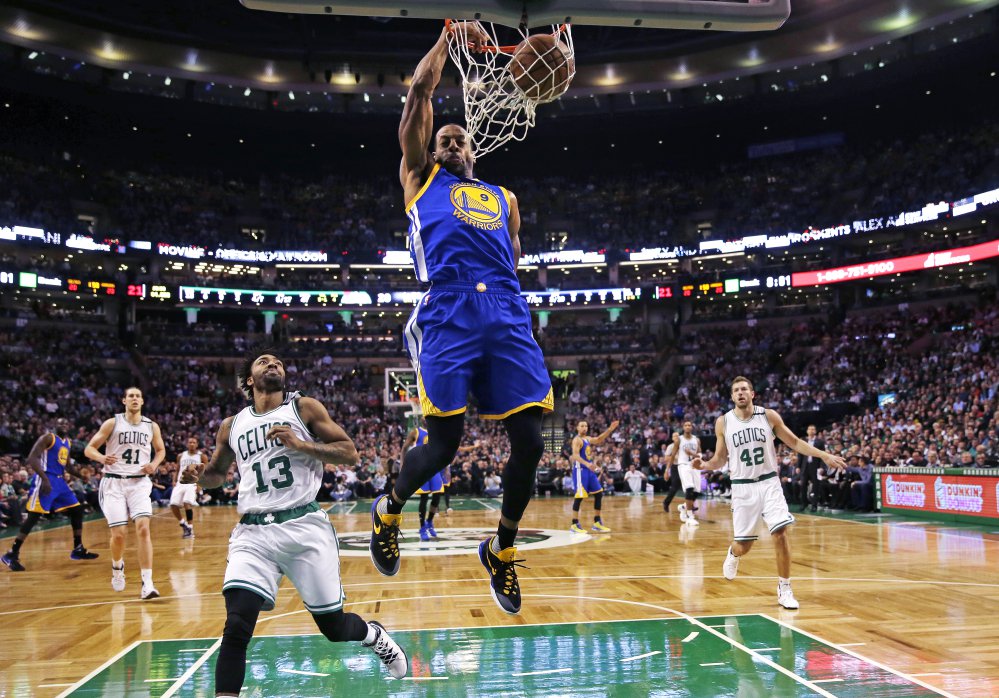 Warriors forward Andre Iguodala slams a dunk over Celtics guard James Young in the first quarter of what turned out to be a very long game – and a Warriors win