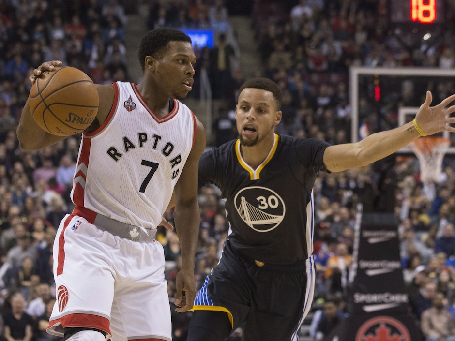 Toronto Raptors&#039 Kyle Lowry looks to make a pass as Golden State Warriors&#039 Stephen Curry defends during first half NBA basketball action in Toronto on Saturday