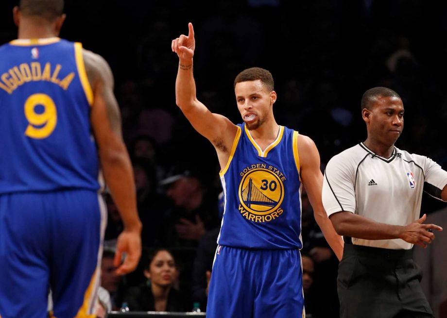 Golden State Warriors guard Stephen Curry reacts after scoring in the second half of an NBA basketball game against the Brooklyn Nets Sunday Dec. 6 2015 in New York. Curry had 28 points as the Warriors defeated the Nets 114-98