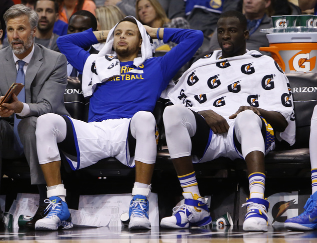 Golden State Warriors guard Stephen Curry left and Draymond Green during the fourth quarter of an NBA basketball game against the Phoenix Suns Friday Nov