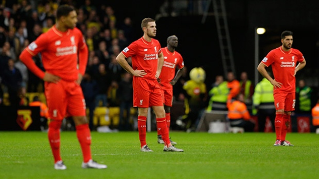 Liverpool's Jordan Henderson second left stands with his teammates as they wait while a Watford player receives injury treatment during the English Premier League soccer match between Watford and Liverpool at Vicarage Road stadium in Watford on Sund