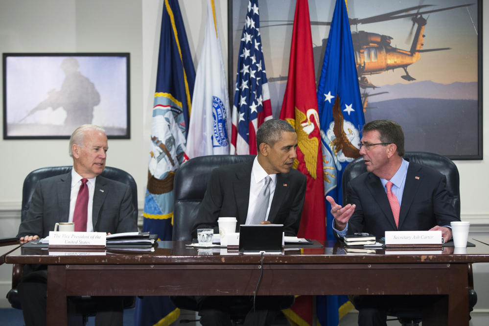 President Barack Obama talks with Vice President Joe Biden and Defense Secretary Ash Carter during a meeting with the National Security Council about the fight against the Islamic State group Monday at the Pentagon