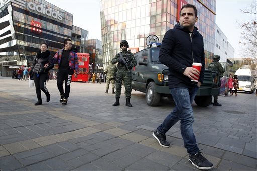 Heavily armed Chinese paramilitary police guard a popular mall in the Sanlitun district of Beijing China Thursday Dec. 24 2015. Increased security could be seen in the area as the U.S. and British embassies in the Chinese capital issued travel alerts