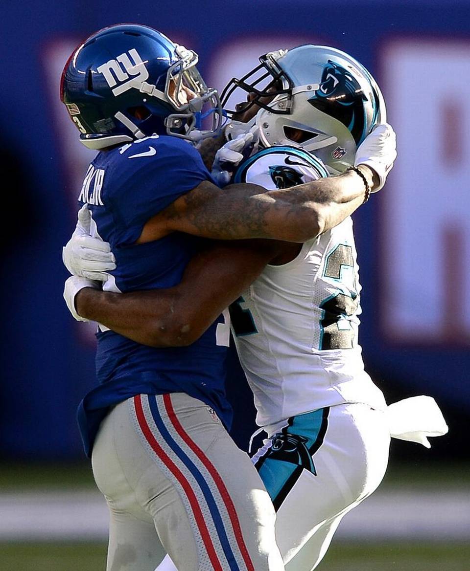 New York Giants wide receiver Odell Beckham Jr. left and Carolina Panthers cornerback Josh Norman wrap one another up during the first quarter of the Panthers’ 38-35 victory on Sunday