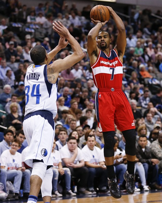 Washington Wizards guard Ramon Sessions shoots over Dallas Mavericks guard Devin Harris during the first half an NBA basketball game Saturday Dec. 12 2015 in Dallas