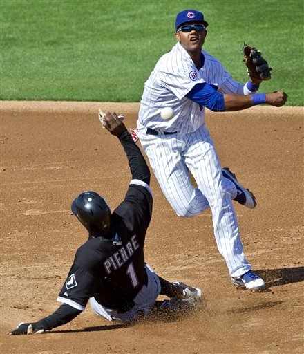 Chicago Cubs&#039 Starlin Castro top forces out Chicago White Sox's Juan Pierre while relaying to first during the third inning of a spring training baseball game at HoHoKam Park in Mesa Ariz. The Cu