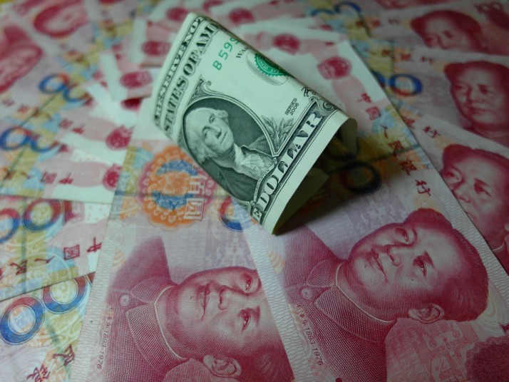 Yuan banknotes and US dollars are seen on a table in Yichang central China's Hubei province | AFP  Getty