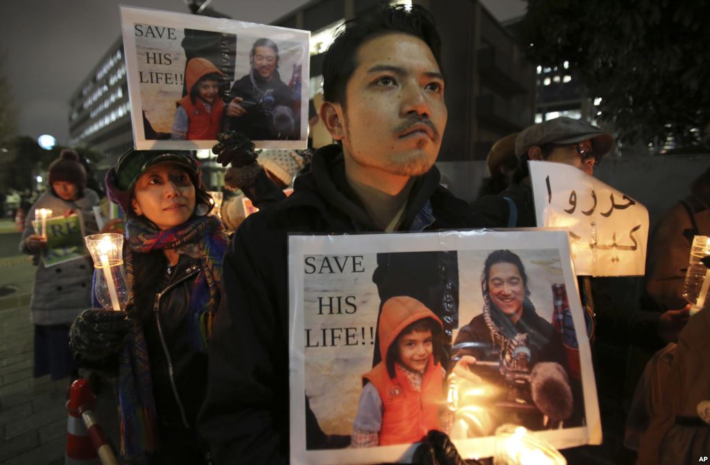 Kenji Goto who was taken hostage by the Islamic State group appeal to the government to save Goto during a rally in front of the prime minister's official residence in Tokyo