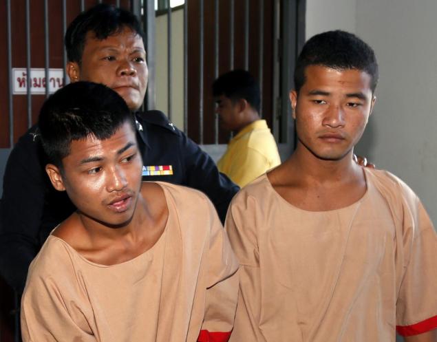 Myanmar migrant workers who are accused of the killing of two British tourists Zaw Lin and Wai Phyo are escorted by a Thai police officer after they were sentenced to death