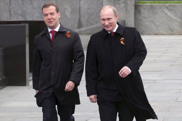 Vladimir Putin and Dmitry Medvedev walk side by side