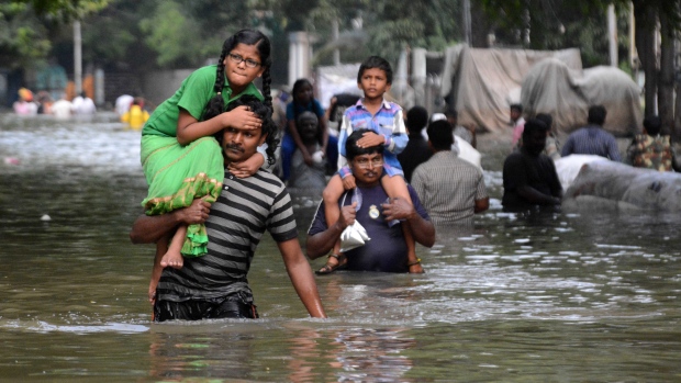 Residents of Chennai India's fourth-largest city took advantage of a break in the weather on Friday to leave their flooded homes after the worst rains in a century hit the southern state of Tamil Nadu