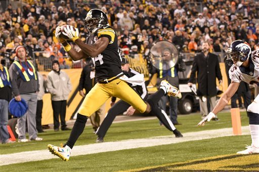 Pittsburgh Steelers wide receiver Antonio Brown catches a touchdown pass behind Denver Broncos cornerback Chris Harris during the second half of an NFL football game in Pittsburgh Sunday Dec. 20 2015