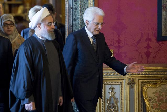 Iran's President Hassan Rouhani walks next to his Italian counterpart President Sergio Mattarella at the Quirinale presidential palace in Rome Italy