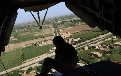 A US helicopter flies over the Marjah district in Helmand Province