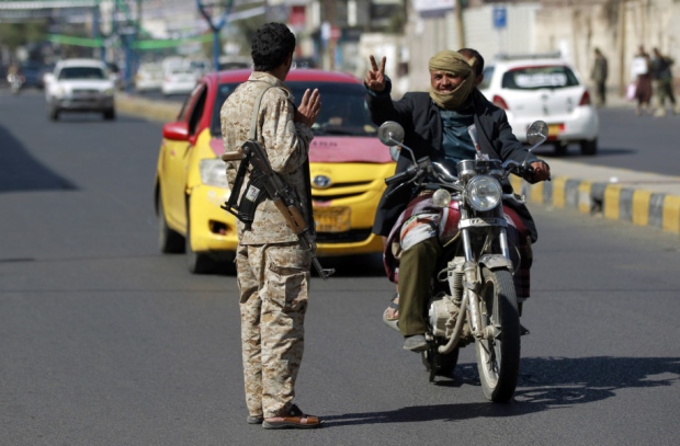 A Yemeni member of Iran-backed Shiite Huthi group mans a checkpoint on a street on in the capital Sanaa