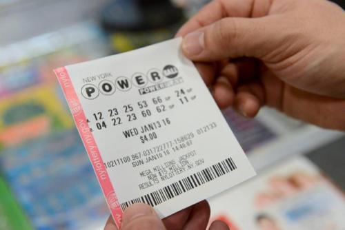 A bettor holds a Powerball ticket in New York