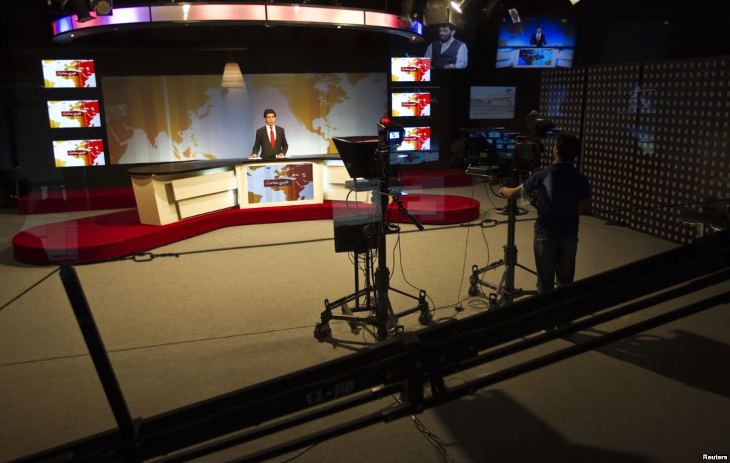 A cameraman films a news anchor at Tolo News studio in Kabul Afghanistan