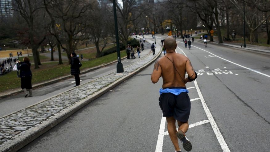 A man jogs during a warm day in Central Park New York