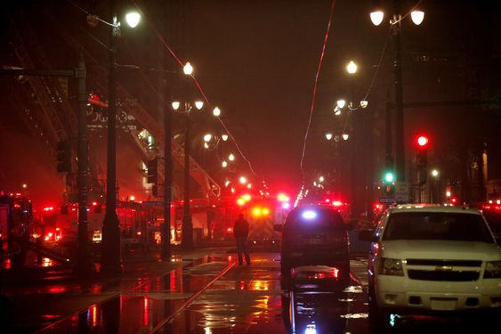 A man watches as firefighters put out a blaze on Canal Street in downtown New Orleans Wednesday Jan. 27 2016