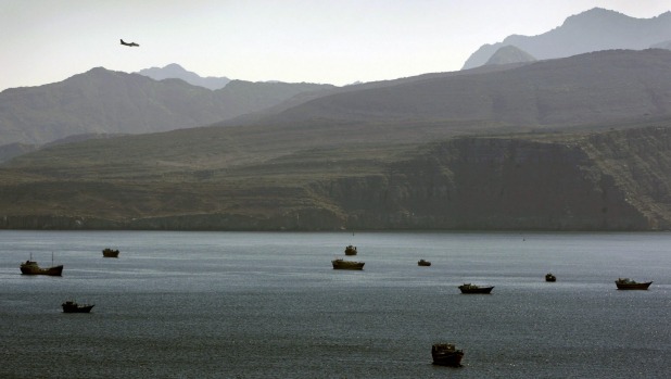 A plane flies over the mountains south of the Strait of Hormuz which separate Iran from the Arabian Peninsula