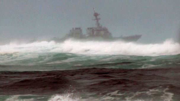 A search vessel cruises the waters off the beach at Haleiwa