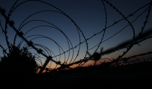 A sunrise is seen through a barbed-wire fence near the Demilitarized zone separating South and North Korea