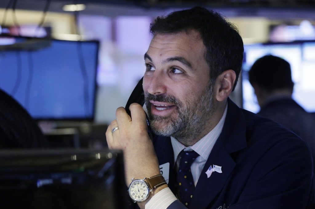 A trader smiles as he follows prices before the opening bell at the New York Stock Exchange Friday Jan. 22 2016. ORG XMIT NYML102