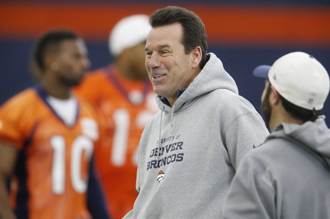 Denver Broncos head coach Gary Kubiak jokes with assistants during the team's NFL football practice Friday Jan. 8 2016 in Englewood Colo