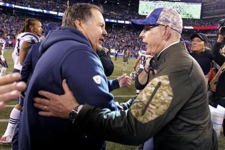 New England Patriots head coach Bill Belichick left and New York Giants head coach Tom Coughlin right meet after an NFL football game Sunday Nov. 15 2015 in East Rutherford N.J. The Patriots won 27-26