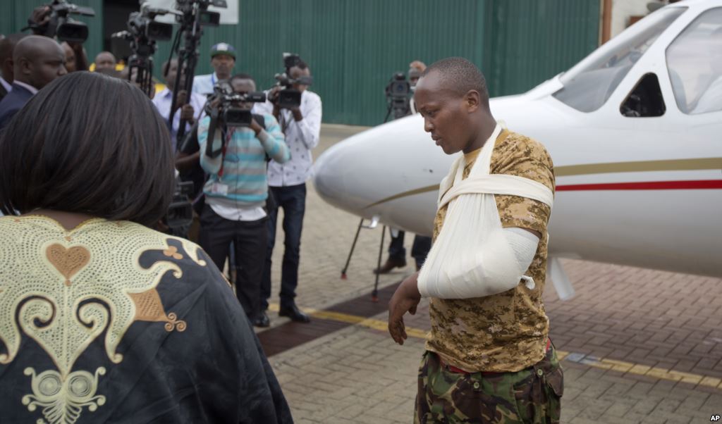 A Kenyan soldier who Kenya Defence Forces said was injured in the attack by al Shabab in Somalia walks from an airplane to a waiting ambulance after being airlifted back to Nairobi for medical treatment Jan. 17 2016