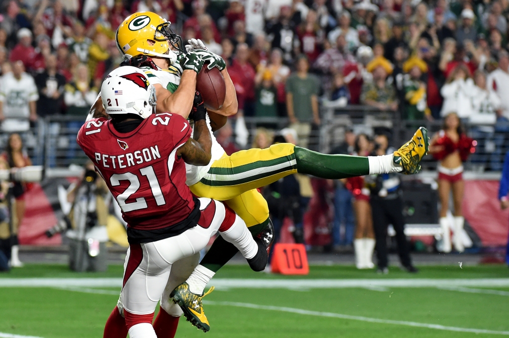 GLENDALE AZ- JANUARY 16 Wide receiver Jeff Janis #83 of the Green Bay Packers catches a 41-yard touchdown on the final play of regulation against cornerback Patrick Peterson #21 of the Arizona Cardinals in the NFC Divisional Playoff Game at University