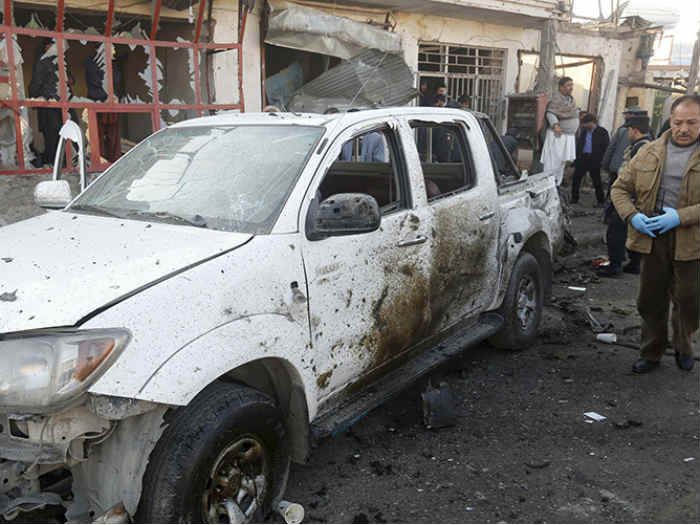 Afghan security forces investigate at the site of a suicide bomb attack in Kabul Afghanistan