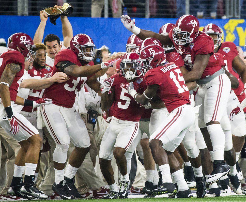 Alabama defensive back Cyrus Jones is mobbed by teammates after intercepting a pass in the end zone during the first half of the Cotton Bowl on Thursday night in Arlington Texas