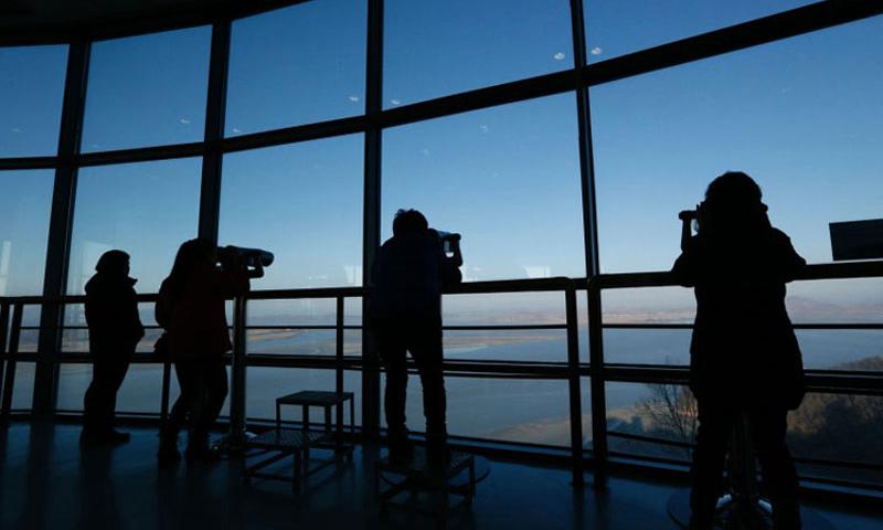 Visitors use binoculars to see North Korean territory from the unification observatory in Paju north of Seoul South Korea on Jan. 7 2016. North Korea says it has arrested an American university student for alleged anti-state acts