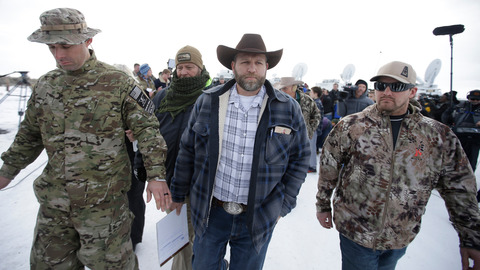 Ammon Bundy center one of the sons of Nevada rancher Cliven Bundy walks off after speaking with reporters