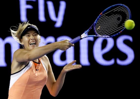 Maria Sharapova of Russia hits a forehand return