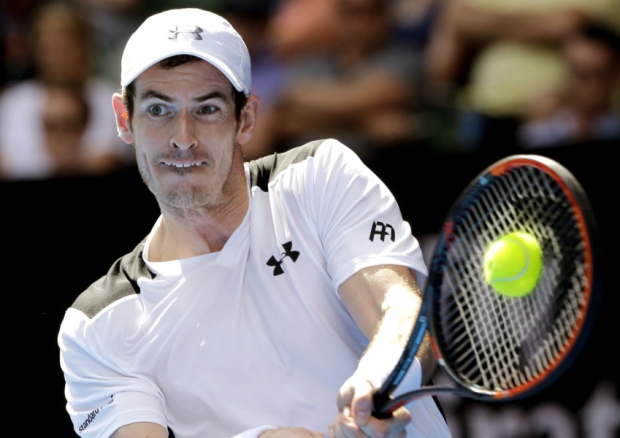 Andy Murray of Britain makes a backhand return to Sam Groth in their second round match