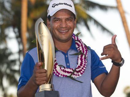 Argentina's Fabian Gomez fashions a Hawaiian'shaka sign as he holds the Sony Open trophy following his play-off victory