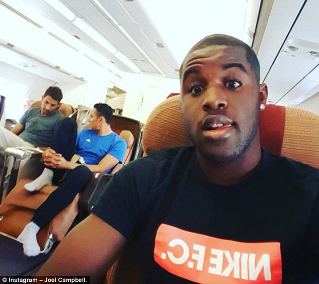 Arsenal winger Joel Campbell poses for a selfie while on an aeroplane with his Costa Rica team-mates