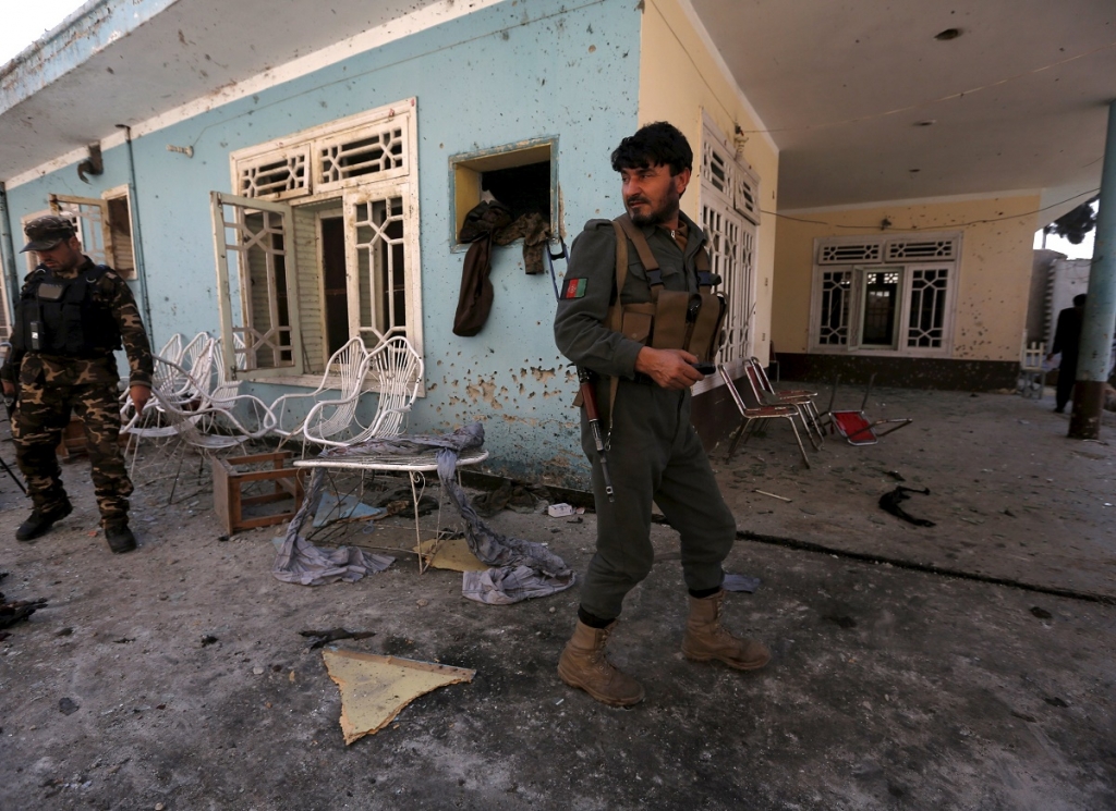 Afghan security forces inspect the site of a suicide attack in Jalalabad Afghanistan today. A suicide bomber killed nine people in the eastern Afghan city of Jalalabad at the home of a tribal elder when people had gathered to celebrate his son's release