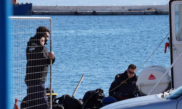 Greek Coast guard officers prepare for a rescue mission at the port of Kalymnos island on Friday Jan. 22 2016. A wooden sailboat carrying an undetermined number of people sank off the islet of Kalolimnos near the Greek southeastern island of Kalymnos. A