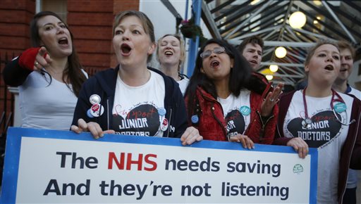 The British National Heath Service Singers who are either doctors or nurses perform a protest song in support of junior doctors outside Great Ormond Street Hospital for Sick Children as a 24 hour junior doctor strike starts in London Tuesday Jan. 12