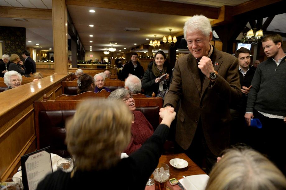 Hitting the campaign trail for the first time for his wife Democratic presidential candidate Hillary Clinton former U.S. President Bill Clinton greets diners at the Puritan Backroom restaurant on Monday in Manchester N.H