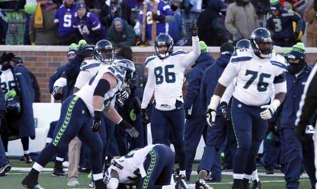 Seattle Seahawks players celebrate after Minnesota Vikings kicker Blair Walsh misses a field goal during the second half of an NFL wild-card football game Sunday Jan. 10 2016 in Minneapolis. The Seahawks won 10-9