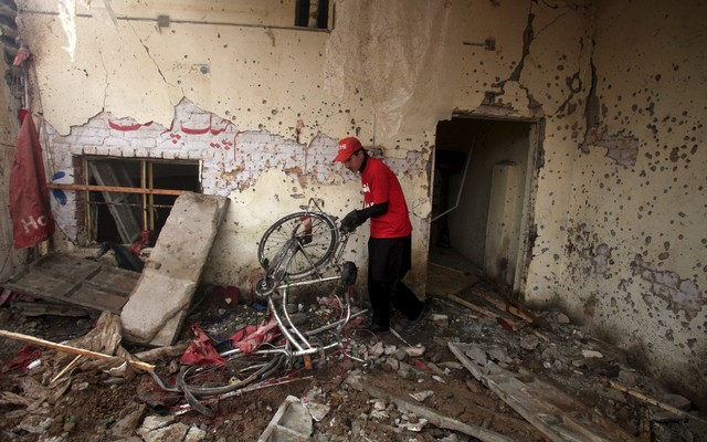 A rescue worker sifts through the rubble after a suicide bomber blew himself up close to a police checkpoint in Peshawar Pakistan Jan 19 2016. Reuters