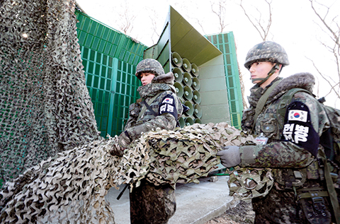 South Korean army soldiers remove camouflage from the loudspeakers near the border area between South Korea and North Korea in Yeoncheon South Korea Friday Jan. 8 2016. South Korea responded to North Korea's nuclear test with broadcasts of anti-Pyongy