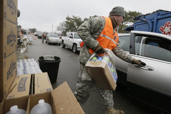 CARLOS OSORIO						Credit AP				Michigan National Guardsmen load bottled water for residents at a fire station Thursday in Flint