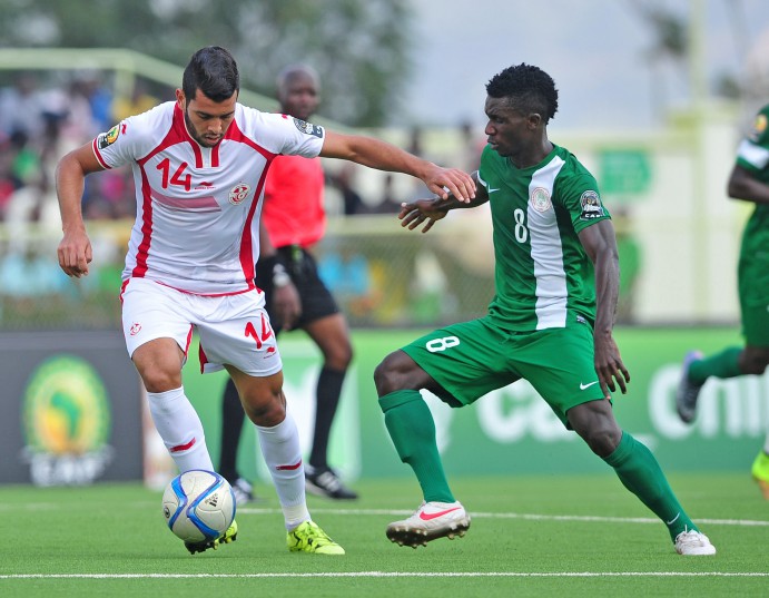 Mohamed Ben Amor of Tunisia is challenged by Matthew Ifeanyi of Nigeria during the 2016 CHAN Rwanda game between Tunisia and Nigeria at Stade de Kigali