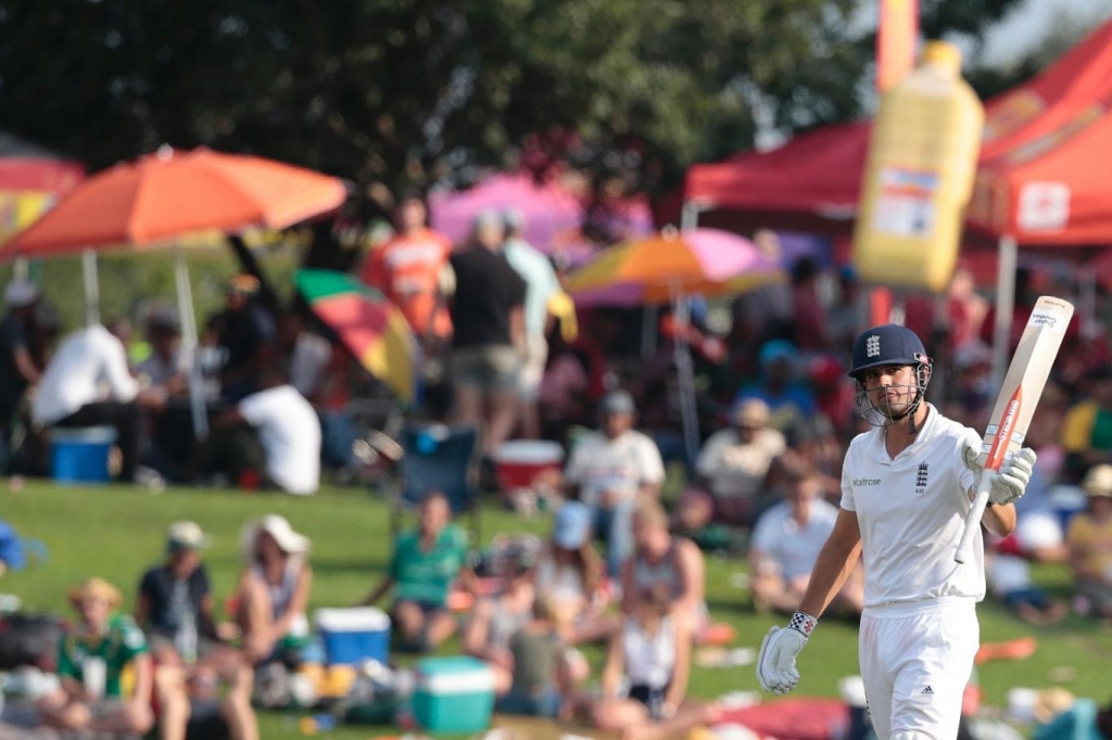 Captain's show Cook raises his bat after securing his half-ton Getty