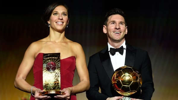 Carli Lloyd and Messi with their trophies on Monday night